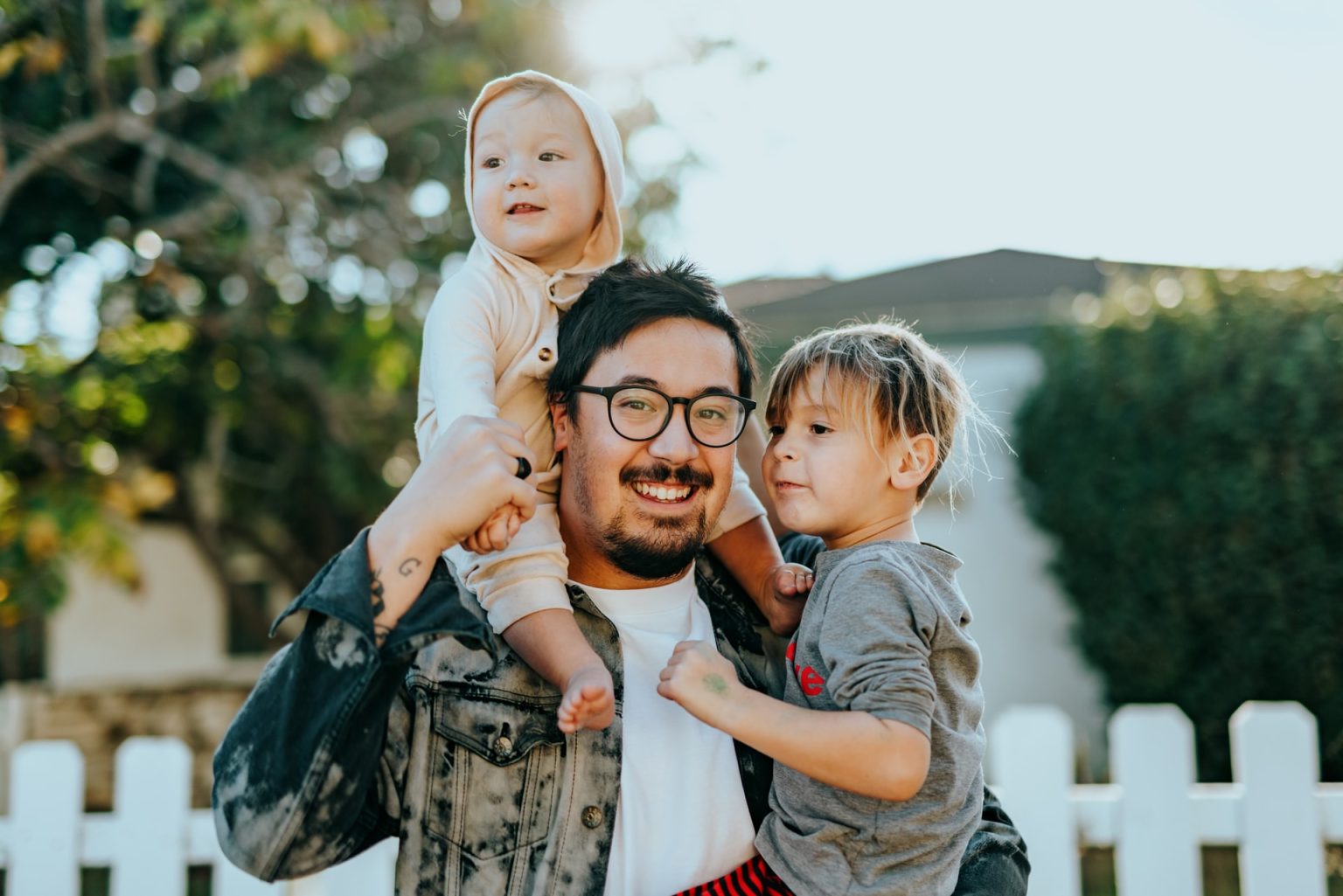 children on dads shoulders