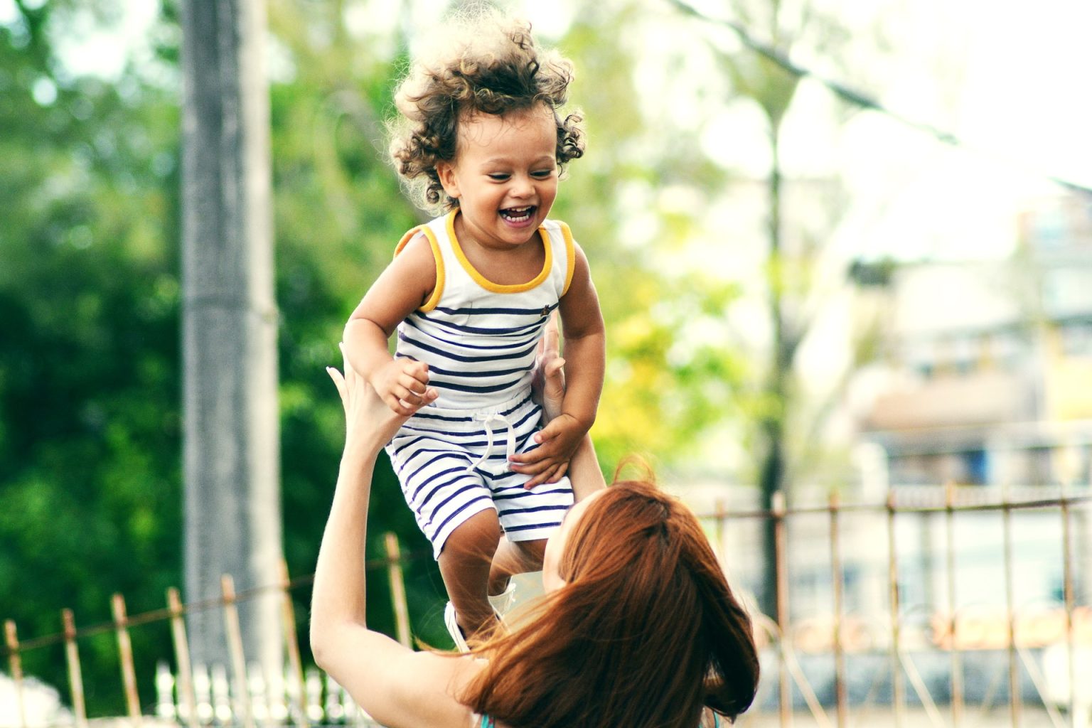 Mpther throwing child in air